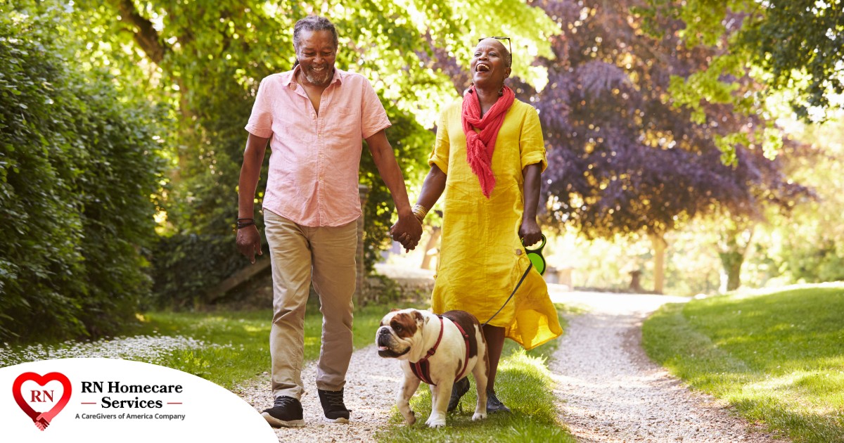 Walks, like this older couple and their dog are engaged in, are great activities for seniors in the springtime.