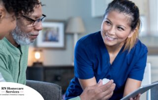 A nurse smiles as she helps an older couple with their medication in the comfort of their own home, showing the benefits of in-home nursing services.